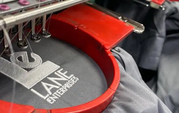 Custom screen printed apparel and vehicle wrap parked in Delano District Wichita by U.S. Logo