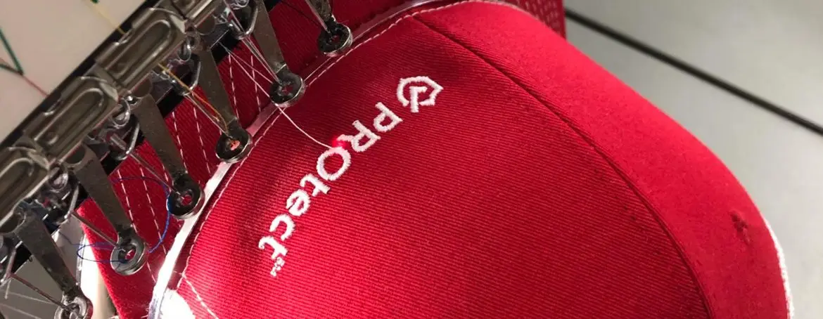 U.S. Logo team applying custom embroidery and screen printing to apparel in Wichita, Kansas